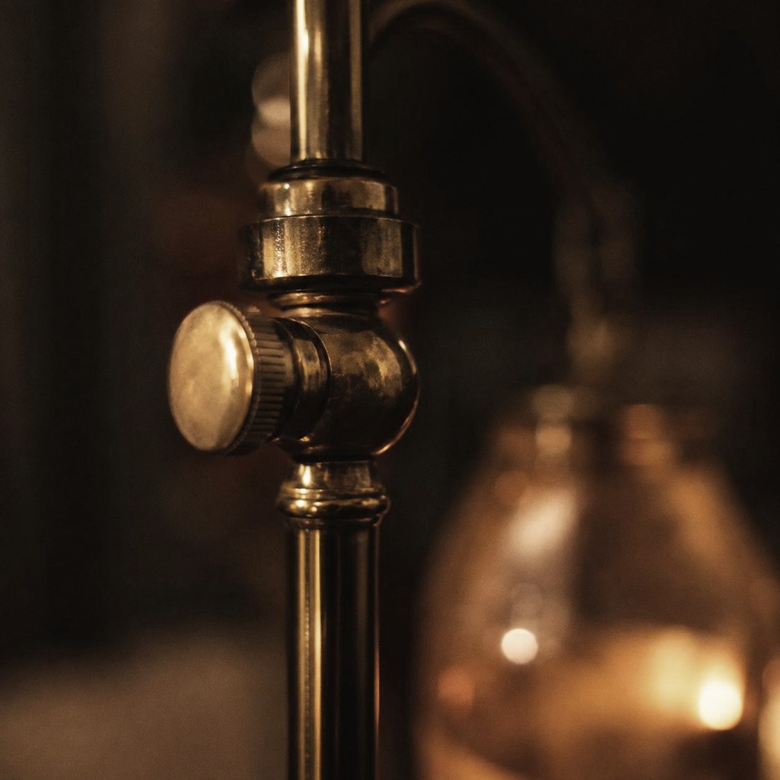 A brass infusion stand beside a chair