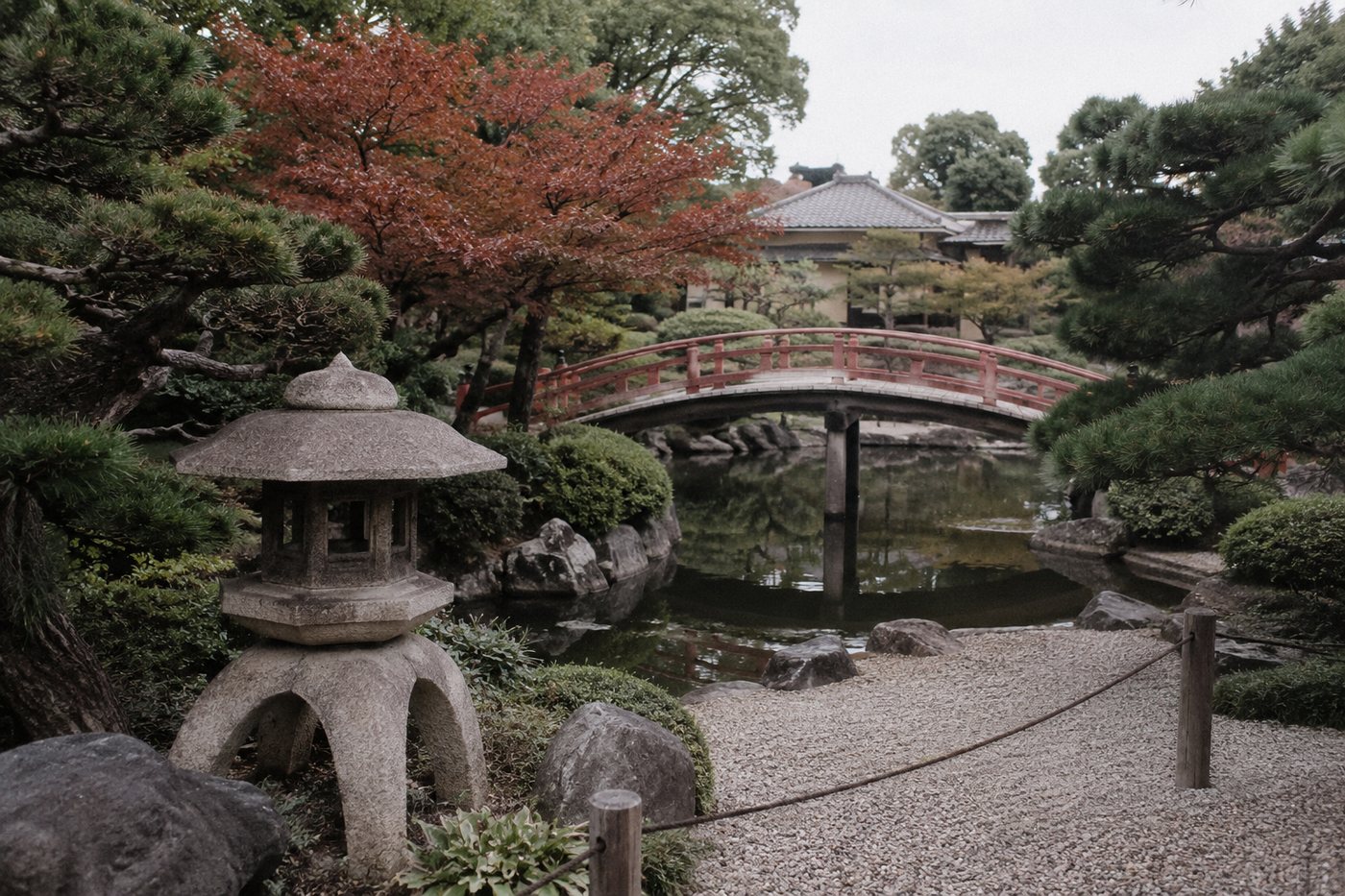 A stone lantern beside the water in a quiet garden in San Mateo